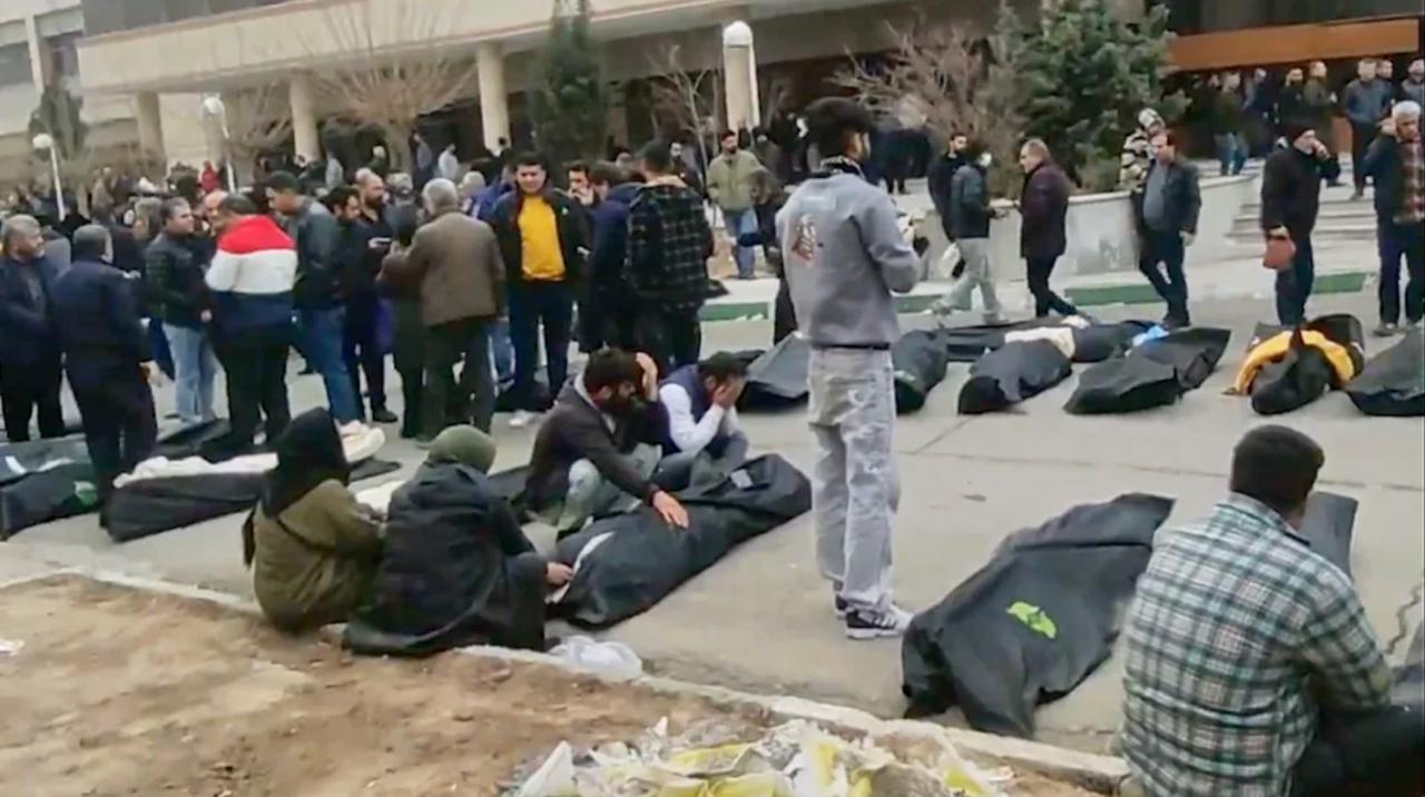 Иранский режим требует с семей убитых протестующих деньги за выдачу тел В Иране родственников убитых во время протестов заставляют платить властям за выдачу тел погибших Речь идет о так называемом деньгах за пули компенсации за боеприпасы которыми силовики застрелили людей По данным правозащитников с семей требуют тысячи евро фактически вынуждая их оплатить убийство собственных близких Эта практика не нова режим аятолл применял ее еще в 1988 году после окончания ирано иракской войны когда были казнены тысячи политических заключенных Если семья отказывается платить тело не выдают для нормального захоронения погибших хоронят анонимно в братских могилах Родственников также заставляют подписывать документы с ложной причиной смерти например сердечная недостаточность вместо указания убийства Похороны разрешают проводить только ночью в узком кругу и под контролем силовиков Несмотря на это в последние дни на кладбищах и у моргов собирались возмущенные родственники скандируя Смерть диктатору в адрес верховного лидера Ирана Али Хаменеи При этом погибших представителей режима в Тегеране демонстративно чествуют как мучеников создавая картинку массовой поддержки властей BILD Russian