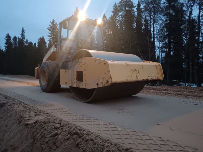 Капитальный ремонт трассы Архангельск Онега набирает обороты на участке от деревни Рикасиха до деревни Кянда примерно 25 8 км где подрядчик ООО Севдорстройсервис выполняет расчистку и планировку полосы отвода ремонт 12 водопропускных труб устройство земельного полотна и двухслойного основания из щебёночно песчано гравийной смеси а также заготовку материалов Работы ведутся по графику под контролем Архангельскавтодора и должны завершиться к концу ноября 2027 года после чего участок получит асфальтобетонное покрытие Проект реализуется в рамках нацпроекта Инфраструктура для жизни с общим финансированием 3 28 млрд рублей на ключевые участки что улучшит связь с территорией опережающего развития Онега На объекте задействовано около 100 человек и 20 единиц тяжёлой техники экскаваторы бульдозеры грейдеры погрузчики катки плюс более 25 самосвалов для инертных материалов Зимой продолжится замена труб всего 24 на смежных участках выравнивание профиля и устройство слоёв смеси благодаря современным технологиям Ранее в 2025 году губернатор Александр Цыбульский посетил стройку отметив вклад в социально экономическое развитие региона Ремонт трассы длиной 138 1 км начался в 2021 году уже приведено в норму 58 5 км Текущий участок 48 60 км от Куртяево завершится к ноябрю 2026 года следующий 60 73 км стартует в феврале 2026 го Дорога входит в опорную сеть с высокой интенсивностью движения ранее была грунтовой и вызывала жалобы жителей