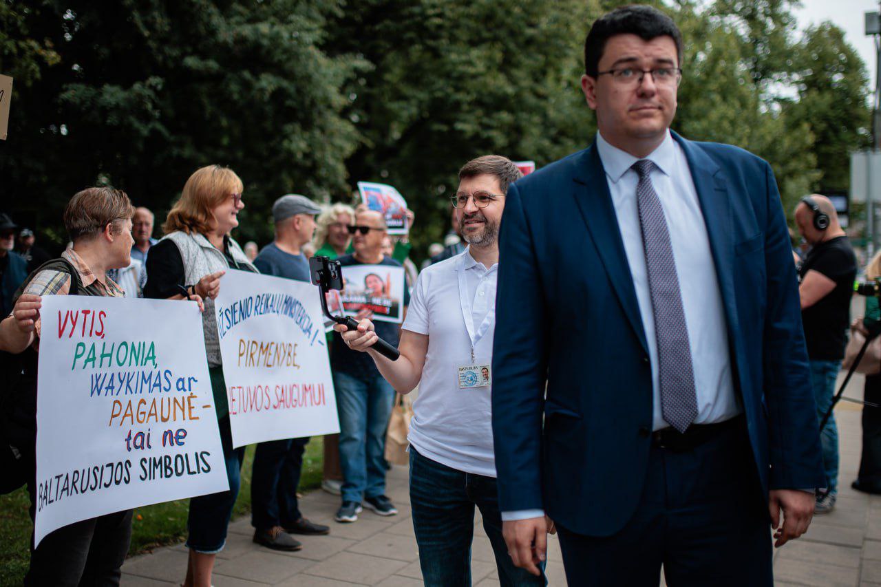 Литовский национал-шовинист, депутат Витаутас Синица организовал протест против присутствия Тихановских и их хевры Литве. Очень боится, что даже такие белорусы Литву захватят. Там плакат у бабки интересный. Перевод: Витис, Погоня, Вайкимас, Пагауне все это разные варианты названия герба - это не белорусский символ. Погоня - символ славянский, как и Синица - славянская фамилия. Литва - это земля не только балтов, но и славян. Белорусы в Виленском крае - это местные жители, имеющие право говорить на своем языке.
