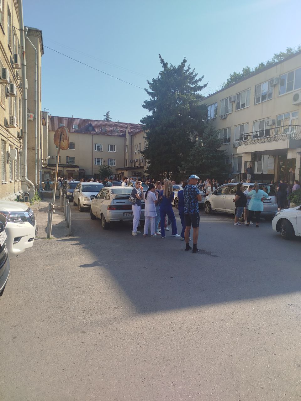 На Сельмаше в Ростове эвакуировали две поликлиники В Ростове-на-Дону эвакуировали детскую и взрослую поликлиники на улице Сержантова. Эвакуация началась еще до 09.00 мск. Десятки людей столпились перед зданиями медучреждений на Сержантова, 3. Едва медучреждение начало работу, как тут же закрылось, а всех пациентов вывели на улицу. Сначала им сообщили, что там случился пожар. Потом оказалось, что причина вовсе не в этом. — Сказали, что ищут кинологов, все вопросы — в полицию, — поделилась женщина информацией от сотрудников поликлиники. В ГУ МВД по Ростовской области пока не пояснили, что на самом деле случилось. Пациенты тем временем продолжают дожидаться открытия медучреждений. Ждать придется немало — начать работу обещают не раньше 12.00 мск. Подписаться на "Новости Ростова" Прислать новость