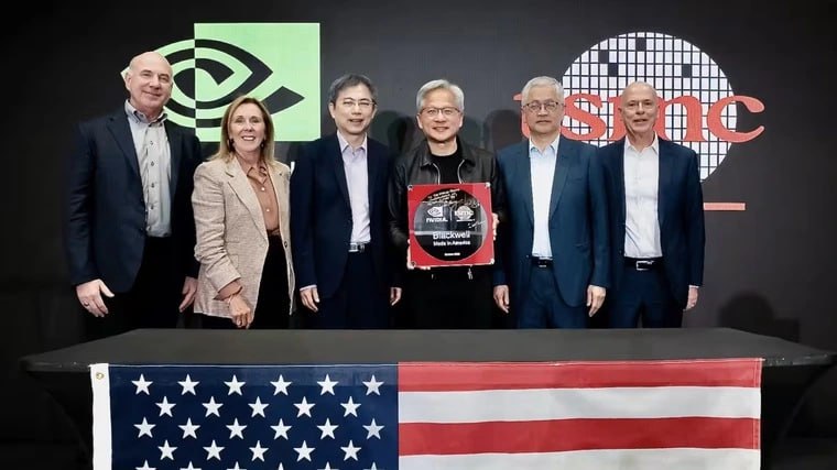 NVIDIA продемонстрировала первые Blackwell произведенные TSMC в США Зеленые отметили что выпуск Blackwell в США на предприятии TSMC в Финиксе укрепляет технологическую независимость страны и обеспечивает лидерство Америки в эпоху ИИ Этот шаг согласуется с видением Дональда Трампа направленного на усиление позиций США в сфере высоких технологий и производства Аризонская фабрика TSMC будет выпускать передовые микросхемы по техпроцессам с нормами 2 3 и 4 нм а также чипы поколения A16 Они необходимы для приложений в области ИИ телекоммуникаций и вычислений TSMC накануне повысила прогноз годовой выручки после публикации рекордной прибыли Компания объясняет рост показателей увеличением инвестиций в ИИ и высоким спросом на передовые микросхемы Nvidia Blackwell США Подписывайтесь на ARCHiTECH
