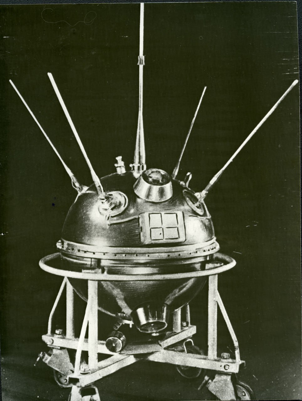 На ФотоДня из коллекции Музея космонавтики автоматическая межпланетная станция Луна 1 во время подготовки к запуску 1958 год Станция стала первым космическим аппаратом запущенным в сторону другого небесного тела Луны Для достижения необходимой скорости близкой ко второй космической в Воронежском Конструкторском бюро химавтоматики был разработан двигатель РД 0105 для блока Е ракеты носителя на базе Р 7 созданного в ОКБ 1 Изначальной целью станции была жёсткая посадка на Луну научная программа включала в себя измерения солнечного ветра подтверждение существования внешних радиационных поясов измерение магнитного поля естественного спутника Земли Для международного подтверждения первого в истории межпланетного запуска астрономы И С Шкловский и В Г Курт предложили сделать из станции искусственную комету испарить 1 килограмм натрия на расстоянии в 120 000 километров от Земли для возможности наблюдения за станцией как за тусклой звездой 6 й величины Из за ошибки в циклограмме полёта ракеты носителя станция не выполнила основную посадочную задачу двигатель блока Е выключился на долю секунды позже дав станции дополнительный импульс из за чего вместо жёсткого соударения с Луной станция пролетела на расстоянии в 6000 километров от её поверхности Несмотря на это Луна 1 стала первым аппаратом достигшим второй космической скорости и первой искусственной планетой которой в советской печати дали наименование Мечта До сих пор станция находится на гелиоцентрической орбите между орбитами Земли и Марса с периодом обращения в 450 дней Некоторые расчёты говорят что в следующий раз траектории Земли и Луны 1 пересекутся в 2109 году Кстати с технологическими дубликатами вымпелов с советской символикой которые несла на борту Луна 1 как и с макетами первых отечественных лунных космических аппаратов вы можете ознакомиться в Музее космонавтики в зале Утро космической эры Открыты для вас в праздничные дни с 10 00 до 21 00 До встречи под ракетой