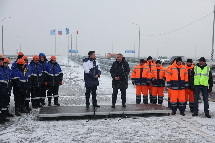 В Светлоярском районе открыли для транспорта второй участок обхода Волгограда протяжённостью 12 км с входящим в него новым мостом через Волго Донской канал В состав участка вошли три разноуровневые транспортные развязки обеспечивающие выезд на элистинское и астраханское направления трассы Р 22 Каспий и региональную дорогу Волгоград Котельниково Сальск Доминанта участка мост через ВДСК Его длина вместе с эстакадой превышает 1 3 км высота пролёта 17 м Для моста строителям потребовалось 23 металлических блока по 100 тонн каждый чтобы надвинуть над каналом сначала правую половину моста затем левую Напомним первый участок обхода Волгограда в 2024 г соединил московскую трассу Р 22 Каспий с ростовской Р 260 Волгоград Каменск Шахтинский Луганск и с областной дорогой Качалино Степной аэропорт Гумрак Третий этап соединит первые два его проект уже прошёл согласование