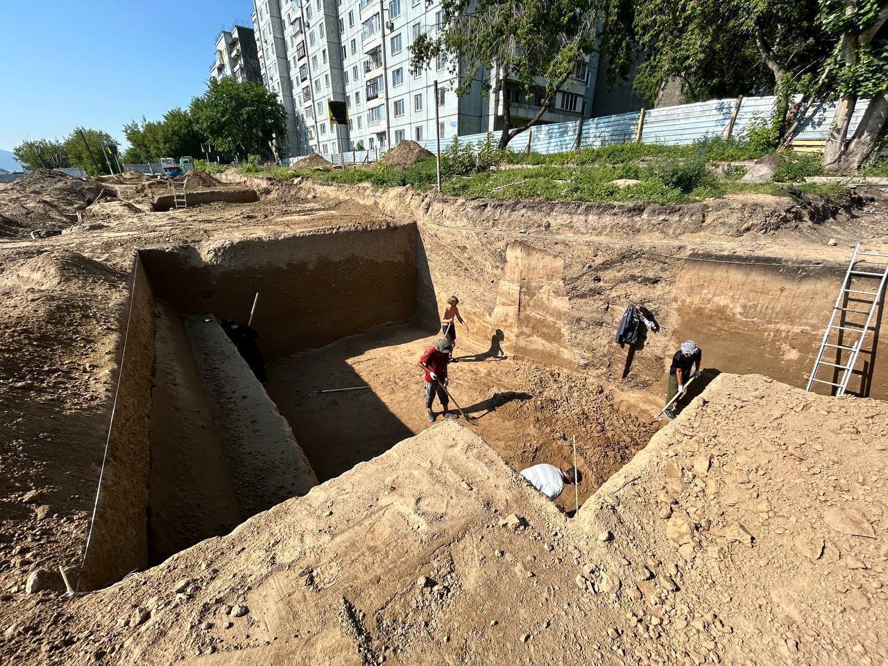 Археологи нашли древнее захоронение прямо на месте будущей дороги в Боготольском переулке   На глубине около полуметра археологи раскопали останки четверых человек — двоих взрослых и двоих детей. По предварительным оценкам, им от двух до трех тысяч лет. Находку относят к тагарской культуре — это эпоха бронзы и раннего железа, когда по берегам Енисея жили кочевники, охотники и ремесленники. Останки уже отправили на экспертизу в СФУ. Там определят возраст, причины смерти и образ жизни этих людей. Археологи уверены: место перспективное, находки точно еще будут.  «На территории Афонтовской горы мы обнаружили и предметы, которым порядка 11 тысяч лет. Это останки животных: рога оленей, древних козлов, бивни мамонтов. Также на участке много скребков – сточенных камней, ими пользовались люди как мы сейчас ножами. Пока изучена небольшая часть площади, я думаю, это место нас еще не раз удивит», — говорит археолог Зоя Гандакова.   Сейчас археологи работают во дворе между домами 8 и 8а на улице Менжинского, рассказали в департаменте градостроительства. Движение на этом участке перекрыто до середины августа. Затем специалисты переместятся ближе к улице Копылова. Археологические исследования здесь продлятся до сентября. Все находки после изучения передадут в краеведческий музей.  После археологов на объект зайдут энергетики, чтобы перенести сети. Параллельно начнется подготовка к строительству новой дороги. По проекту она соединит улицы Копылова и Новосибирскую.   Это Борус.Люди