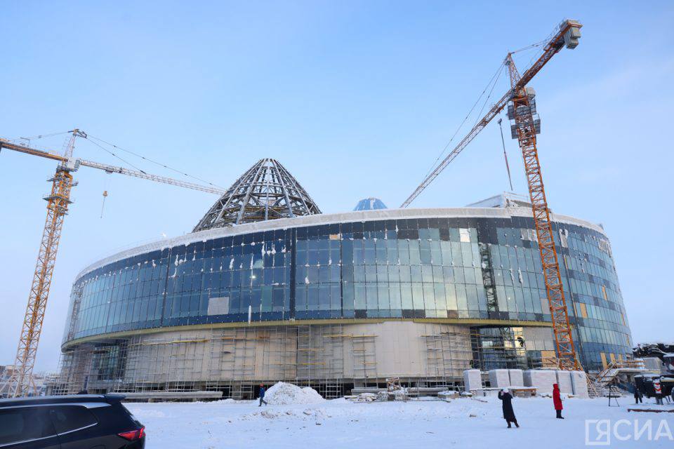 Готовность здания Арктического центра эпоса и искусств в Якутске составляет почти 60%  В Якутии продолжается строительство единого комплекса Государственной филармонии и Арктического центра эпоса и искусств. Здание общей площадью почти 33 тыс. кв. м и высотой 36,7 метра объединит филармонию, два театра, а также пространство для выставочных и деловых мероприятий. Общая вместимость зрительных залов составит 1530 мест.  «Уникальность этого комплекса заключается именно в этом, поэтому мы его называем культурным кластером, потому что он предоставляет много возможностей для развития культуры и работы различных творческих коллективов»,  — сказал руководитель департамента по корпоративным коммуникациям Группы «ВИС» Сергей Козловский.  Строительная готовность объекта составляет 58%. Проводятся работы по установке перегородок на семи этажах, штукатурке, утеплению и гидроизоляции полов. Начат монтаж сценического оборудования в филармонии. На объекте задействованы 217 человек и 12 единиц техники.    Все новости   #Яестьновость   Обсудить