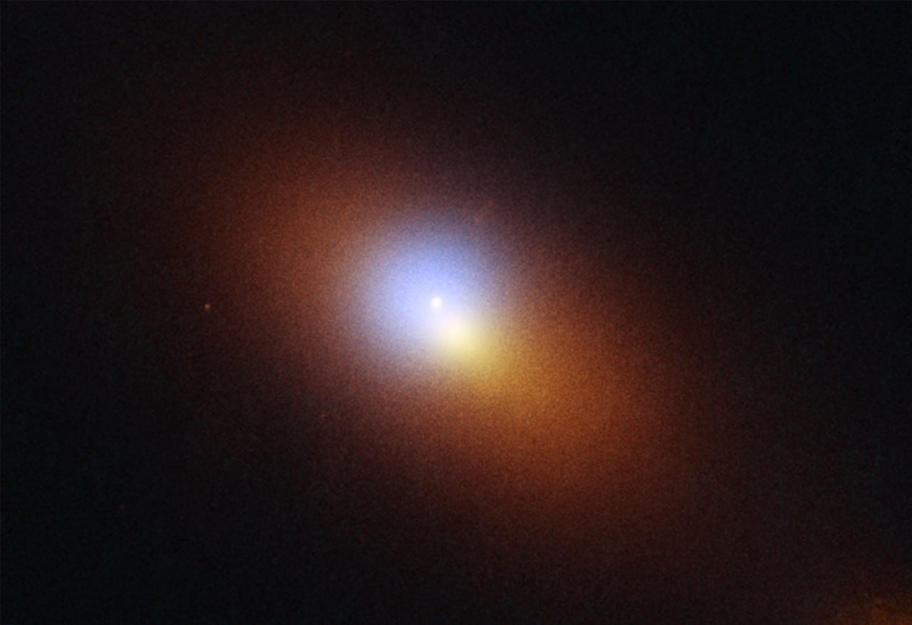 Hubble поймал "бродячую" чёрную дыру за поеданием звезды Астрономы впервые засекли чёрную дыру вдали от центра её родной галактики в момент, когда она буквально разрывала звезду на части! Событие, получившее название AT2024tvd, произошло на расстоянии около 600 миллионов световых лет от Земли. Что делает это открытие уникальным? Обычно сверхмассивные чёрные дыры обитают в самом центре галактик, но эта оказалась "бродягой". Несмотря на внушительную массу в миллион солнц, она расположена в 2600 световых годах от центра своей галактики, где притаилась ещё более массивная чёрная дыра весом в 100 миллионов солнц. Яркую вспышку от разрушения звезды сначала заметил обзорный телескоп Zwicky Transient Facility, а затем космический телескоп Hubble сделал детальные снимки места происшествия. Этот случай стал первым известным "нецентральным" приливным разрушением звезды — явлением, при котором звезда растягивается и разрывается колоссальной гравитацией чёрной дыры. Астрономы годами искали доказательства существования "бродячих" сверхмассивных чёрных дыр. По словам Райана Чорнока, профессора астрономии Калифорнийского университета в Беркли: "Теоретики предсказывали, что популяция массивных чёрных дыр вне центров галактик должна существовать, но теперь мы можем использовать приливные разрушения звёзд, чтобы найти их". Откуда взялась эта космическая бродяга? У астрономов есть две версии. Возможно, чёрная дыра была выброшена из центра в результате мощного космического взаимодействия с участием нескольких чёрных дыр. Либо она прибыла из меньшей галактики, которая слилась с более крупной больше миллиарда лет назад. Поймать чёрную дыру в момент поглощения звезды — большая удача. По оценкам учёных, массивная чёрная дыра пожирает звезду примерно раз в 30 000 лет.