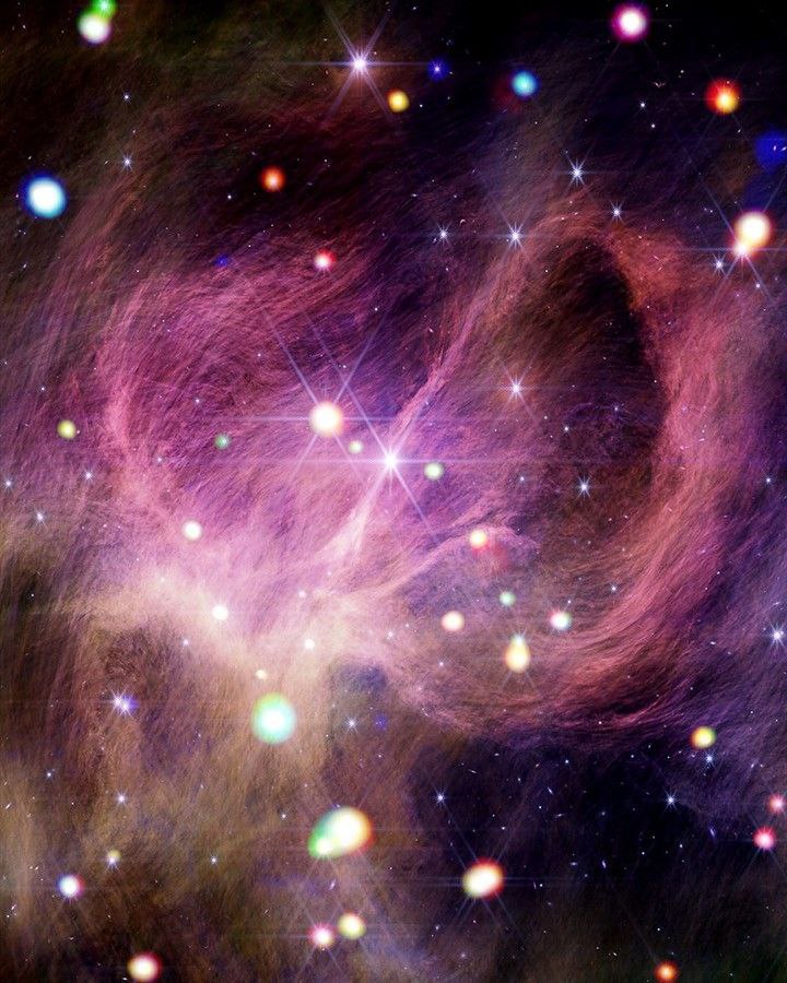 Немного космической укладки   Объединив данные обсерватории Чандра и телескопа Джеймс Уэбб учёные НАСА получили потрясающий снимок звёздообразующей области На нём можно разглядеть розовые словно тонкие пряди волос межзвёздные нити Ближе к центру кадра сияет пара самых массивных звёзд в этом скоплении Их мощные ветра укладывают окрестное вещество формируя большую дугу справа на снимке НАСА ЛидерствоСША
