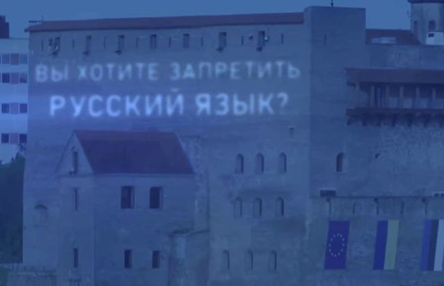 В Сети обсуждают видео с посланием властям Эстонии на здании в Нарве. В эстонской Нарве на стене здания появилась проекция с посланием властям республики, которые намерены запретить русский язык на территории страны. Соответствующее видео распространилось в сети. Видео, предположительно, было снято утром 6 июня, когда отмечается День русского языка. На кадрах видно, как прожектор осветил стену здания в Нарве. Этот город расположен на границе с Россией. Происходящее засняли очевидцы на телефон, предположительно, жители российского Ивангорода. "Хотите запретить величественный, могучий, многообразный, гармоничный, вечный, литературный, неповторимый, многогранный русский язык?" — задается вопрос в послании. Вскоре на стене здания появился соответствующий ответ-предупреждение: лаконичный, но нецензурный. Позже глава администрации Ивангорода Юрий Паршин сообщил журналу «Подъем», что, скорее всего, данная видеозапись является монтажом. По его словам, жители города наверняка бы заметили такую крупную проекцию на стене здания, и тогда появилось бы множество других видео с разных ракурсов. Тем не менее в Сети существует только одно такое видео.