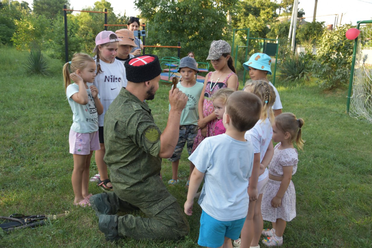 Популяризация казачьих традиций среди молодежи   Для казачьей молодежи организовали мероприятие, направленное на популяризацию казачьей культуры. Оно проходило на площадке «Локомотив» в городе Абинске.   Организаторами выступили представители муниципального отделения Союза казачьей молодежи Кубани совместно с председателем Денисом Рашитовым, сотрудники Центра по физической культуре, массовому спорту и работе с молодежью города Абинска при поддержке депутатов.   В рамках программы были организованы игровые и образовательные площадки. Денис Рашитов рассказал участникам о ключевых аспектах казачьей культуры, уделив особое внимание традиционным элементам казачьего костюма. Кроме того, продемонстрировал навыки владения шашкой, нагайкой и кинжалом. В завершение мероприятия депутат Нина Божок вручила детям мороженое, после чего участники сделали общее фото на память.