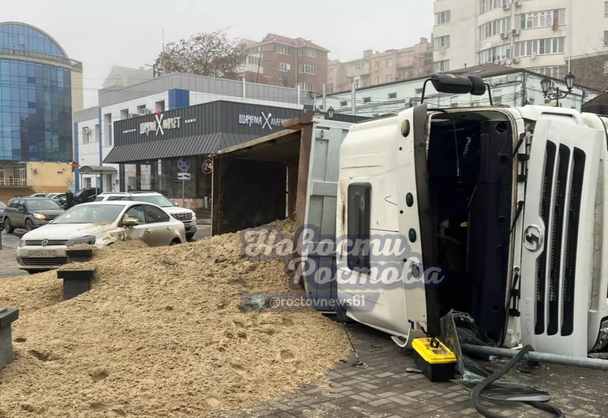 На набережной в Ростове груженый песком грузовик завалился на бок    На набережной в Ростове произошла авария с грузовиком. Инцидент случился 11 декабря около 8:30.    На пересечении улицы Береговой с переулком Семашко фура марки «МАН», груженая песком, завалилась на бок. Вероятно, водитель грузовика не справился с управлением на повороте. Машина снесла дорожный знак и завалилась на бок. Песком засыпало всю проезжую часть и припаркованный рядом автомобиль.    К счастью, движение из-за аварии на участке не затруднено.   Подписаться на "Новости Ростова"    Прислать новость